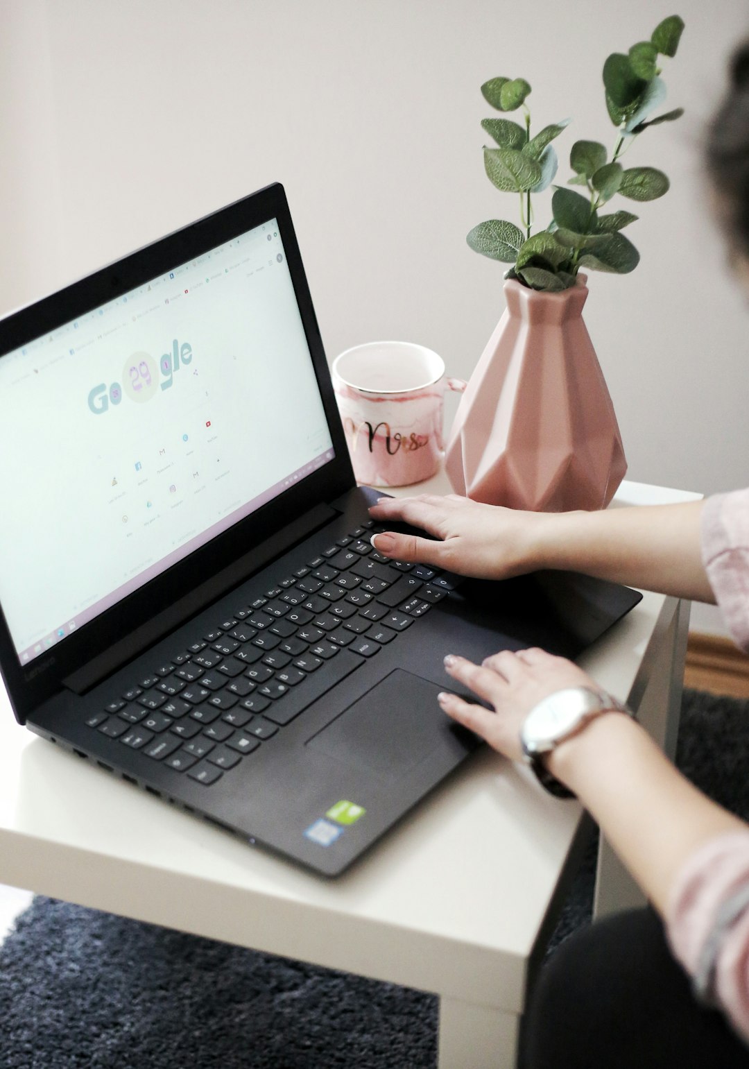 a-person-holding-a-cup-and-a-laptop-kiq3m4vyytk